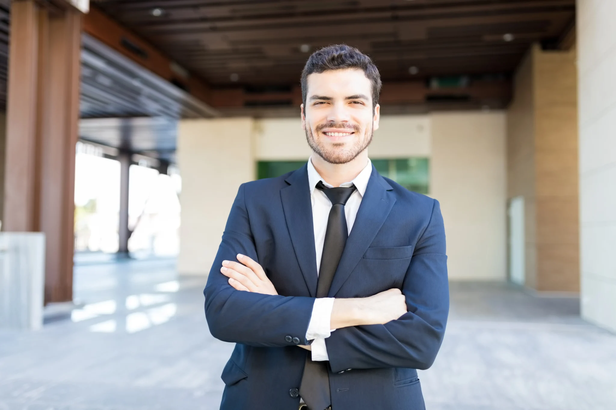 portrait-good-looking-hispanic-businessman-standing-arms-crossed-outside-office (1)